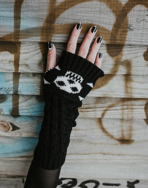 chunky knit black gloves with white skull and crossbones