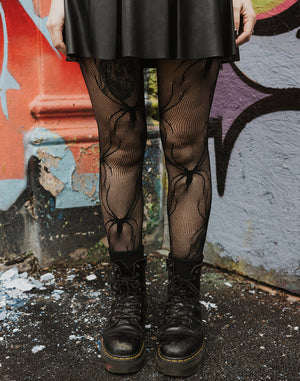 Close up of Net tights with spider pattern from Pamela Mann's wholesale alternative tights range